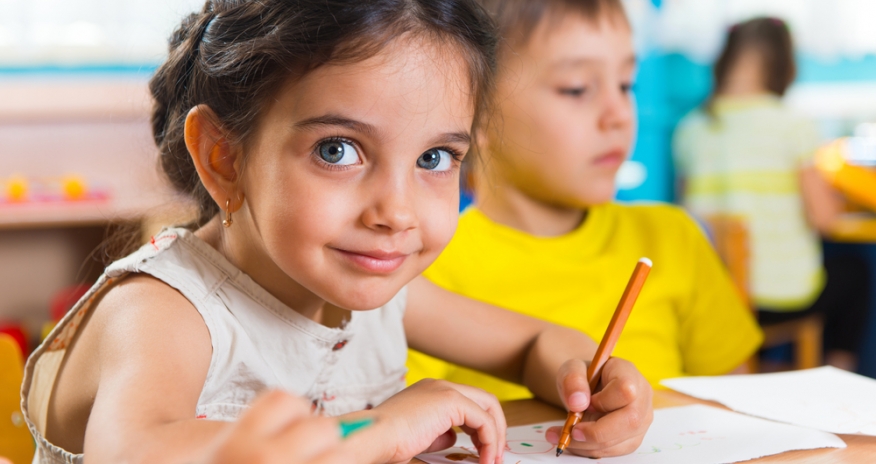 Get Ready for School Little girl and boy sitting in a classroom