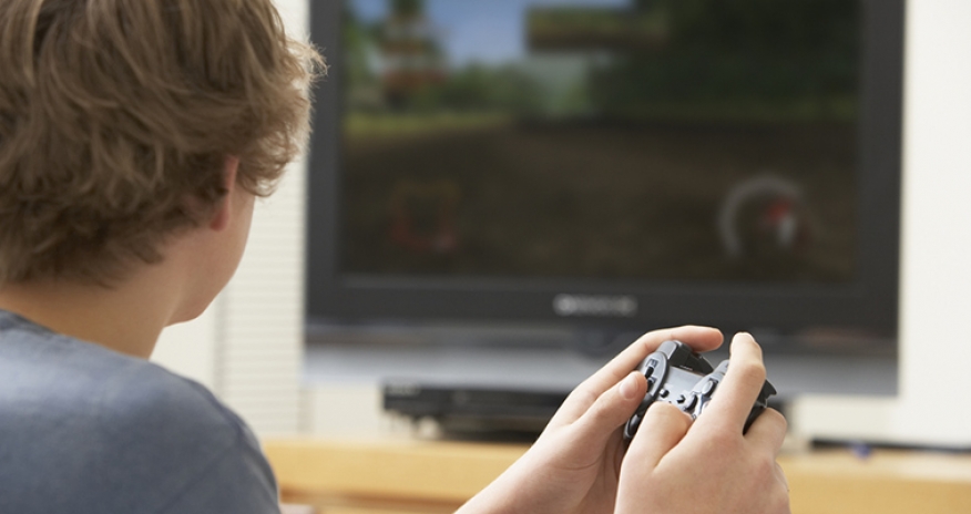 PS4 Gaming a teen boy playing a video game