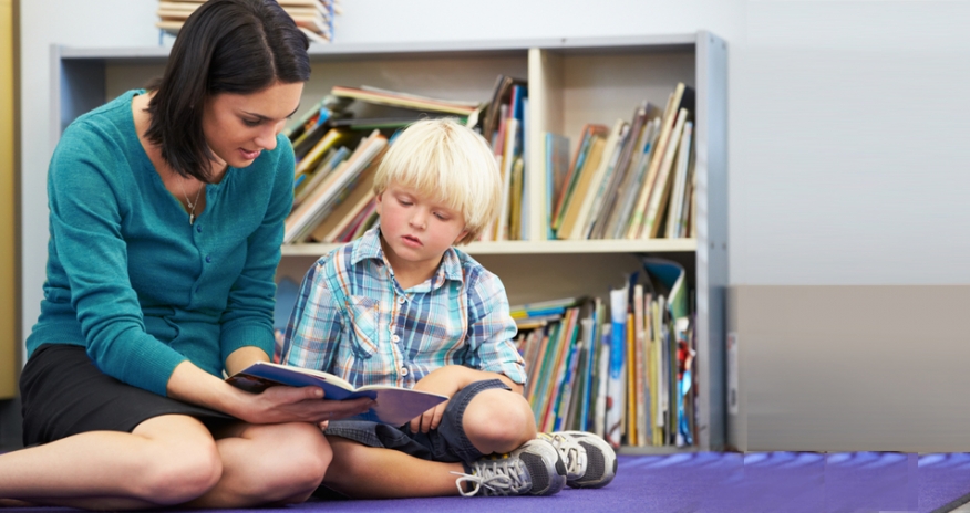 Reading Buddies Woman reading with a young boy
