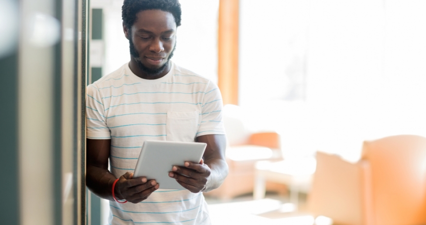 Tablet Club with Teen Volunteers Young man holding tablet