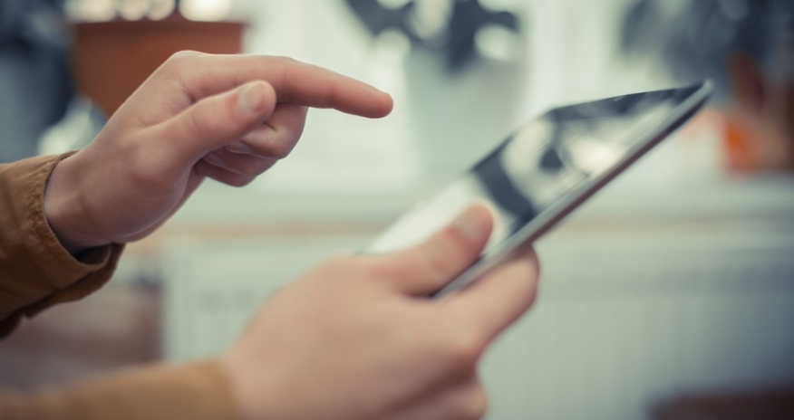 Tech Help Closeup of hands holding a tablet