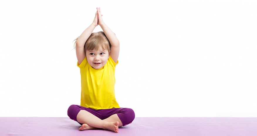 Y on Wheels: Yoga toddler girl sitting on a yoga mat