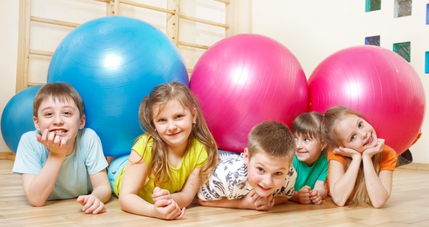 A group of children playing with exercise balls