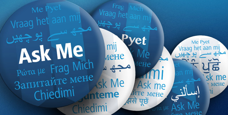 a graphic of a pin button with the text Ask Me and its various translations in other languages
