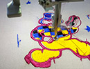 Close up of a clown design being embroidered