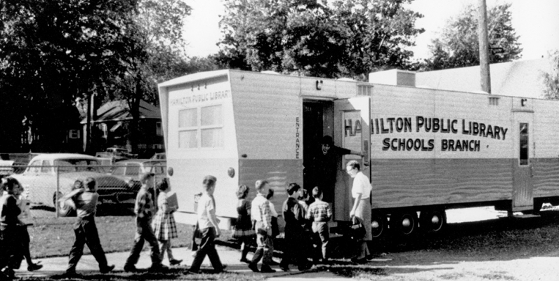 History of the Bookmobile Archival photo of children entering the Hamilton Public Library Bookmobile circa 1960s