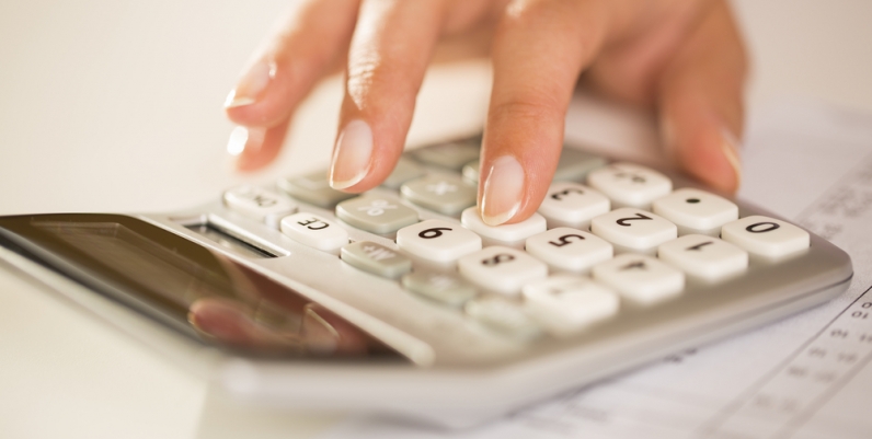 Closeup of a woman's hand using a calculator