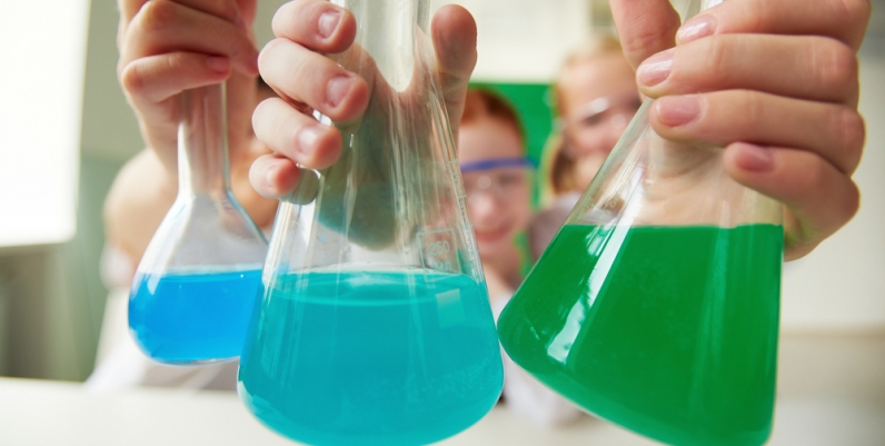 Closeup of children holding beakers