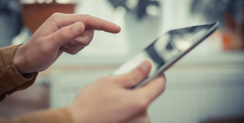 Closeup of hands holding a tablet