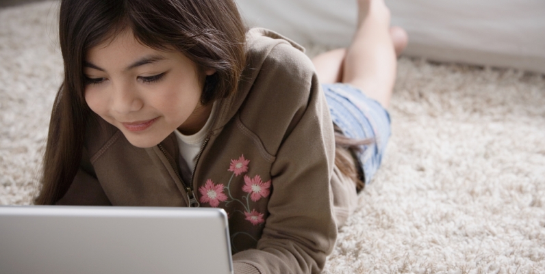 Tween girl using laptop 