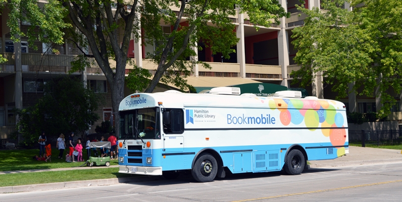 The HPL Bookmobile Photo of the HPL Bookmobile parked on the street in front of an apartment building