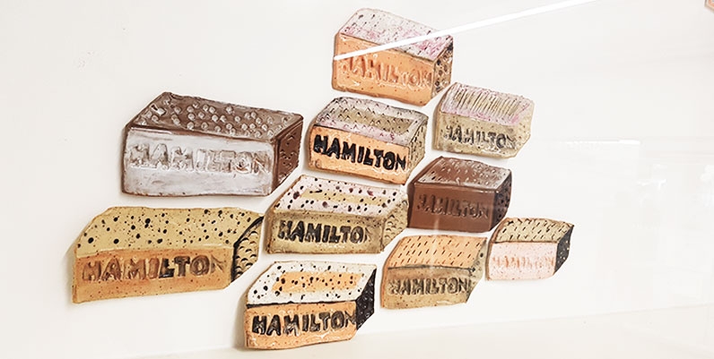 Gallery 4 First Floor: Denise Higginson ceramic of various bricks with the word Hamilton on them
