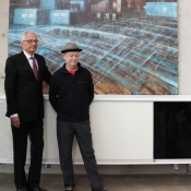 two men in front of a painting