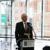 a man speaking behind a podium 