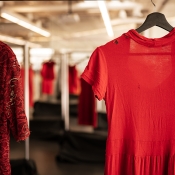Two red dresses hanging in focus. 
