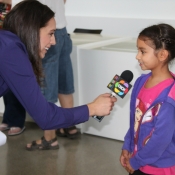 a photo of a reporter interviewing a girl