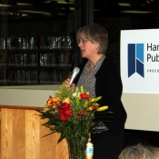 a photo of a female behind a podium delivering a statement