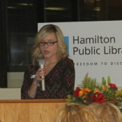 a photo of a female behind a podium delivering a statement