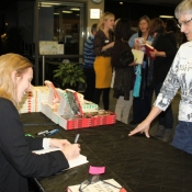 a photo of miriam toews signing her book