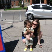 Child and parent outside getting ready to draw on the ground with chalk