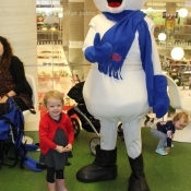 Young girl posing with Chimo the snowman