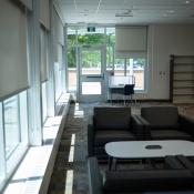 Tables and chairs inside the new greensville branch near a window