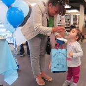 a photo of a mom feeding her daughter cake