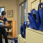 female putting together goodie bags