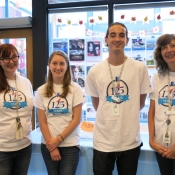 a group of people wearing anniversary shirts