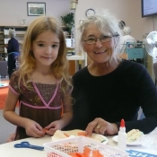 grandma and grand daughter at a crafting table