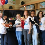 group of people with puppets in front of puppet stage