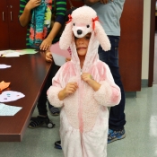 a girl wearing a poodle onesie