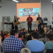 3 males performing to a crowd