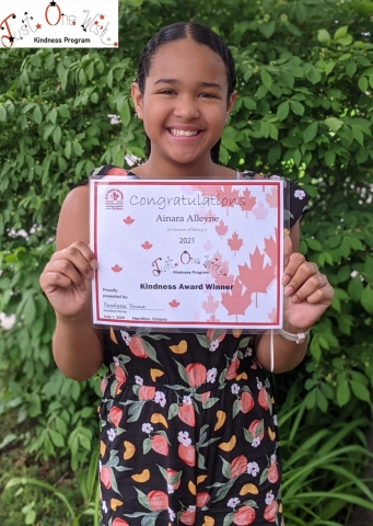 Ania, HPLs Junior Librarian in Residence holding her award