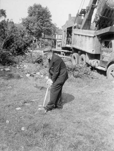 Mayor Jackson digs the first shovelful of dirt for the construction of City Hall, 1958