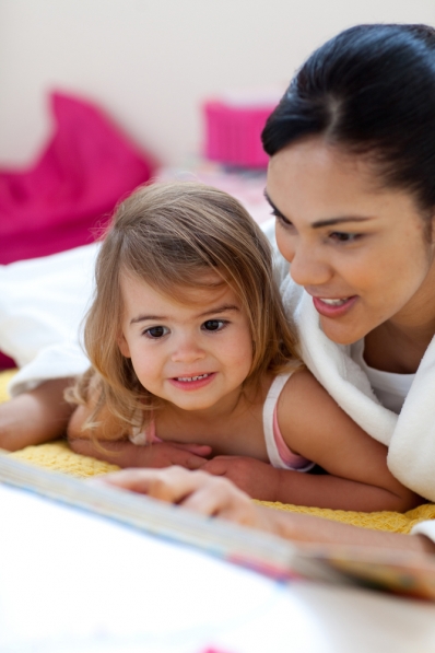 Mother reading with young daughter