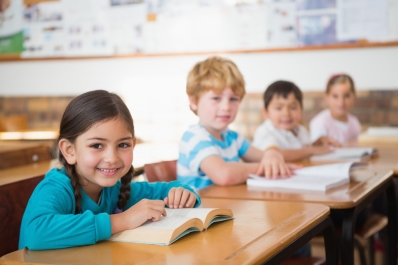 Children sitting at desks in a classroom