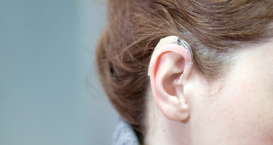 Connect Aid Photo of a woman's ear wearing a hearing aid